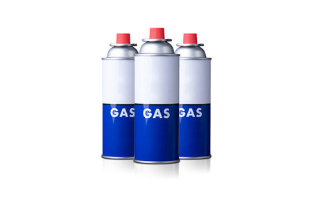 Portable gas cylinder for portable gas appliances with closed red cap isolated on white backgroundの写真素材
