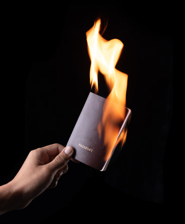 Burning a passport on black backgroundの写真素材