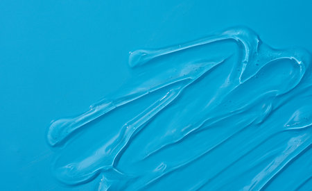 Cream gel cosmetic lubricant background transparent smudge on blueの写真素材
