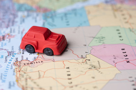 Air travel concept. Toy car model on the mapの写真素材