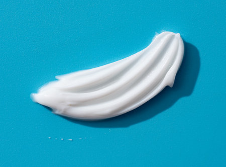 Cosmetic smears of creamy texture on a blue backgroundの写真素材