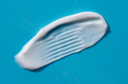 Cosmetic smears of creamy texture on a blue background