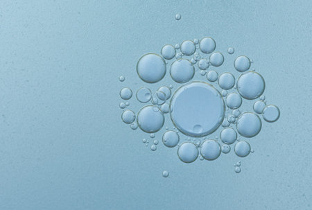 Oil with bubbles on blue background