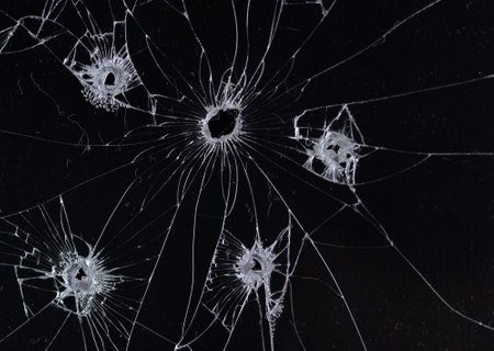 Broken glass bullet holes isolation on black background,Cracked glassの写真素材