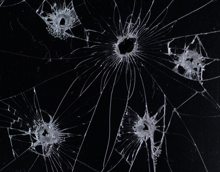 Broken glass bullet holes isolation on black background,Cracked glassの写真素材