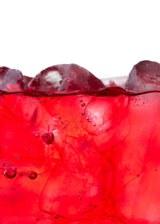 Red carbonated drink with ice,strawberry soda and ice splashing fizzing or floating up to topの写真素材