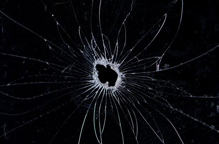 Broken glass bullet holes isolation on black background,Cracked glass