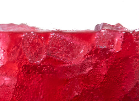 Red carbonated drink with ice,strawberry soda and ice splashing fizzing or floating up to topの写真素材