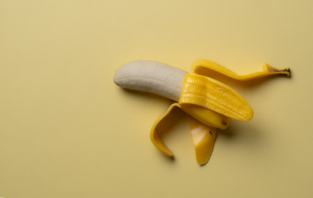 Ripe bananas on yellow backgroundの写真素材