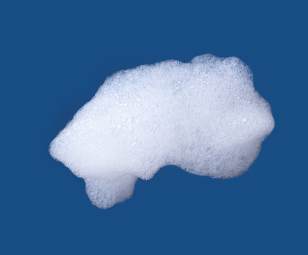 White foam isolated on blue background.の写真素材