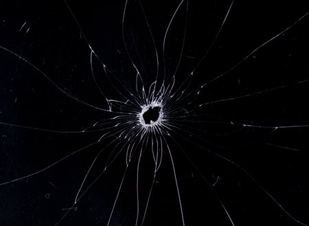 Broken glass bullet holes isolation on black background,Cracked glassの写真素材