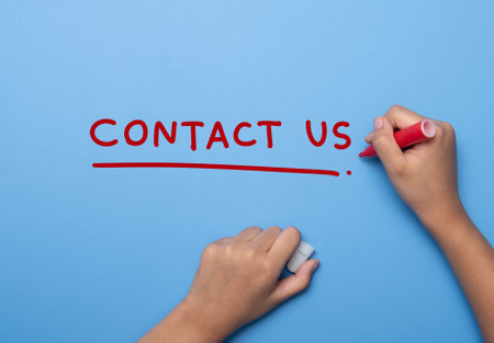 Hand writing CONTACT US with marker, concept backgroundの写真素材