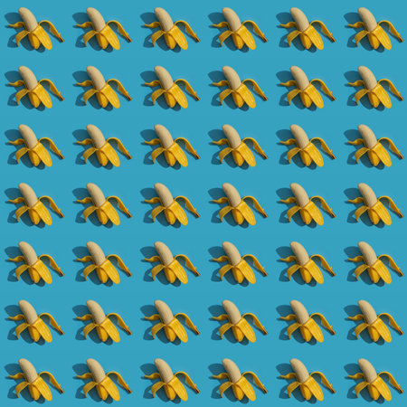 Pattern of bananas with shadows on blue surfaceの写真素材