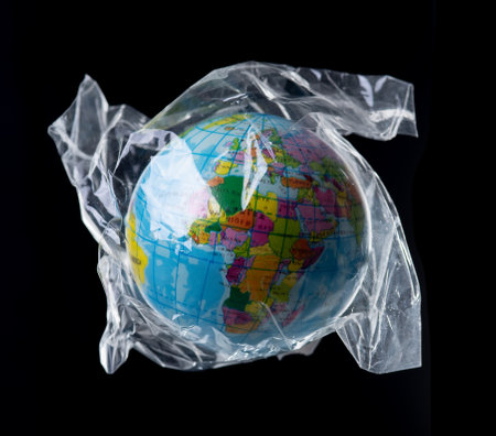 Inflatable globe in a plastic bag,Plastic pollution concept.の写真素材