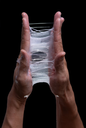 Test for sticky cosmetic lotion or gel against a black backgroundの写真素材