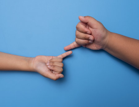 Two people making a bet in front of a blue background,Unity conceptの写真素材