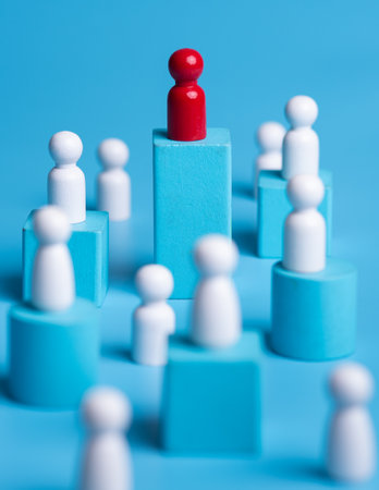 Red wooden figure standing on wooden podium for business leadership for team leader concept.の写真素材
