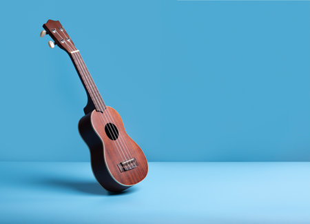 Wooden ukulele guitar on blue backgroundの写真素材