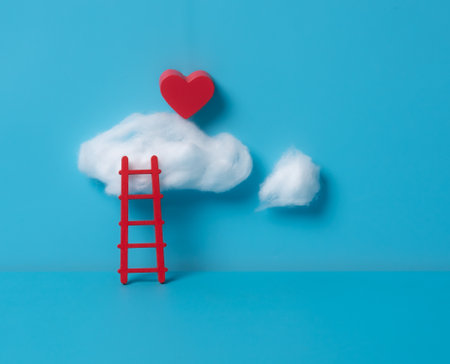 Serene wooden ladder with a red heart-shaped cloud floating on a blue backgroundの写真素材