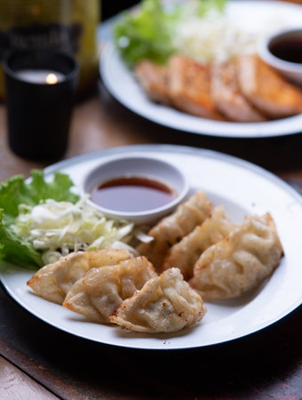 Japanese fried gyoza dumplings with soy sauceの写真素材