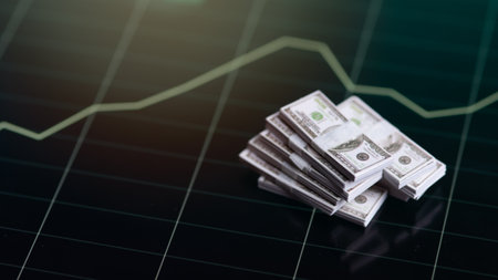 Banknotes over digital screen with real life exchange chart, USD EUR parity concept, Concept of wealth and investmentの写真素材