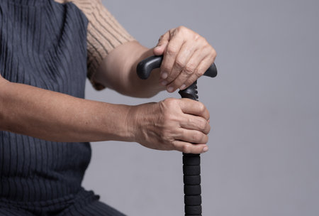 Hands of old woman asia with a cane walking stickの写真素材