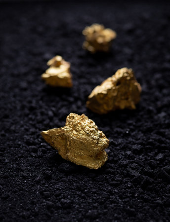 Gold nuggets on small pieces of strong metal ore. closeup. gold nuggetの写真素材