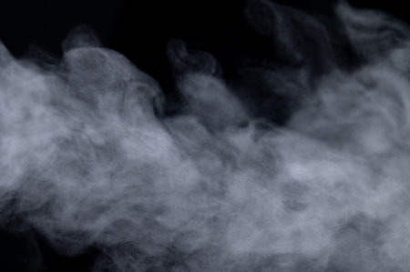 White smoke isolated on black backgroundの写真素材