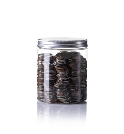 Coins in jar isolated with white backgroundの写真素材