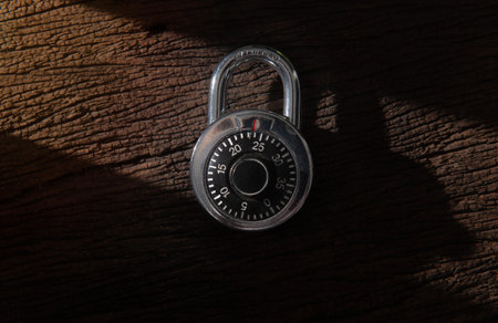 Combination padlock with shadow on wood backgroundの写真素材