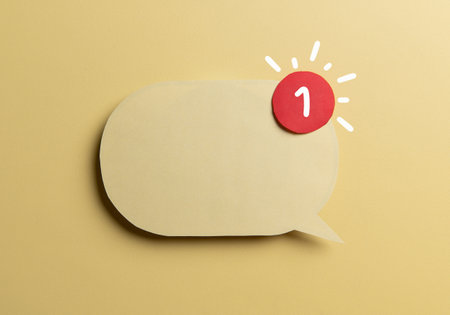 Yellow speech bubble with red notification badge on yellow background. Concept of new message alert, email communication,の写真素材
