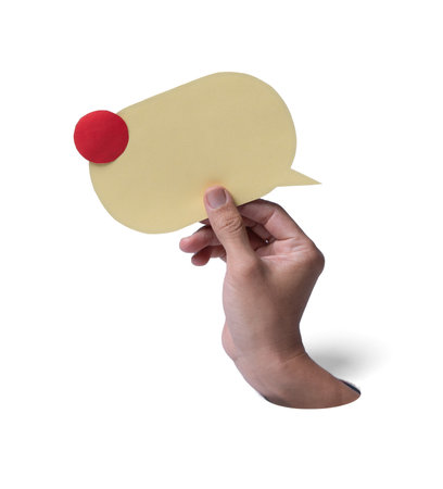 Male hand hold yellow speech bubble with envelope and red notification badge breaks through white paper background. Concept of new message alert, email communicationの写真素材