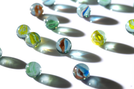Glass marbles with shadow isolated on white backgroundの写真素材