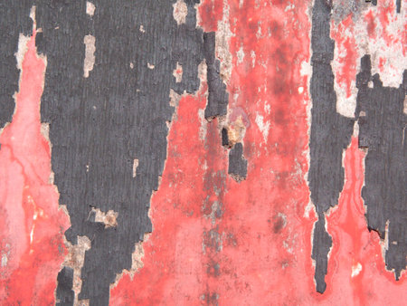 Peeled red paper poster on a wallの写真素材