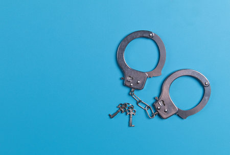 Handcuffs and Keys on a blue backgroundの写真素材