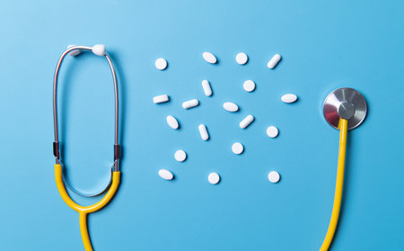 Medical background. Many different various medicine tablets or pills on blue with stethoscope. Healthcare pharmacy and medicine conceptの写真素材