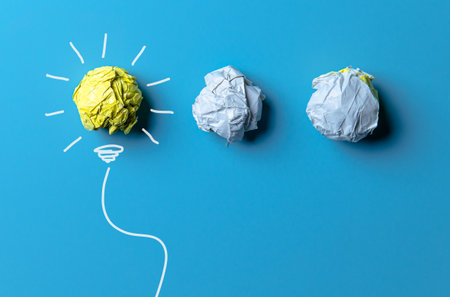 Idea with yellow crumpled paper ball ( lightbulb ) and businessman. Creative concept.