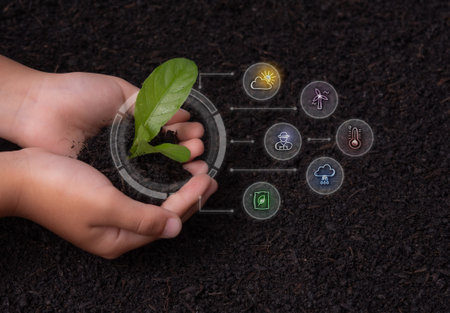 Hands holding soil with green plant and environmental icons seedling growthの写真素材