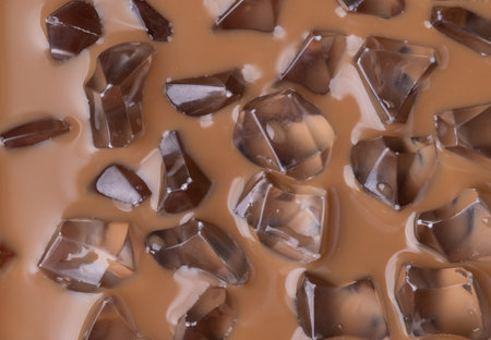 Cold iced coffee texture close up detail with ice cubes, summer holiday drink background.の写真素材