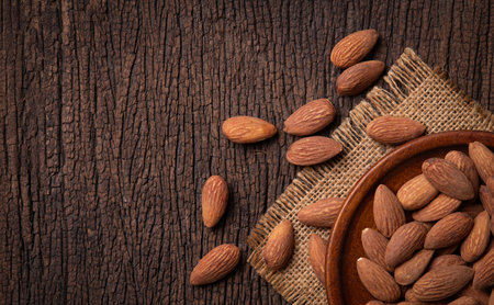 Bowl of almonds on a wooden surfaceの写真素材
