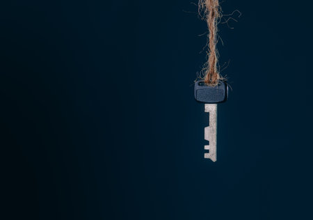 Old rusty keys hanging on dark abstract background with copy space. Security conceptの写真素材