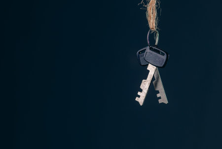Old rusty keys hanging on dark abstract background with copy space. Security conceptの写真素材