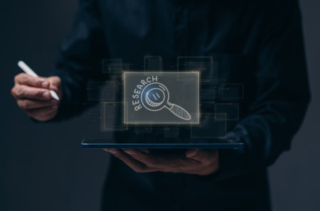 research, business, people and education concept - Business man using laptop with marker drawing magnifierの写真素材