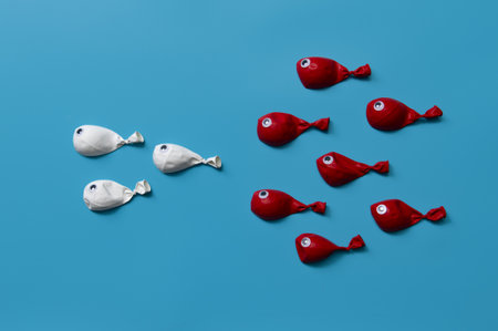 Different business concept.new ideas.Leadership concept with white fish balloons leading among red...