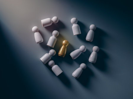 Gold wooden figures stand out from the crowd of wooden figures. Leadership concept,top view