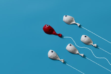 Different business concept.new ideas.Leadership concept with red fish balloon leading among white fishの写真素材