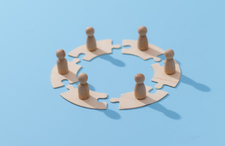 Wooden Pawns on Interlocking Puzzle Pieces: Teamwork and Collaboration Concept