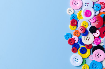 Colorful Assortment of Sewing Buttons on Blue Background