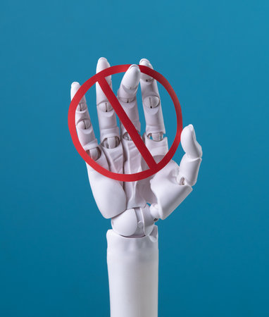 AI Prohibition: Robotic Hand Holding a Red No Signの写真素材
