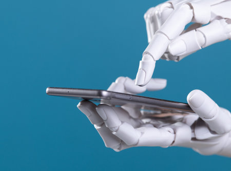 Robot Hand Using Finger to Touch Smartphone or Tablet Screen: AI and Mobile Technologyの写真素材